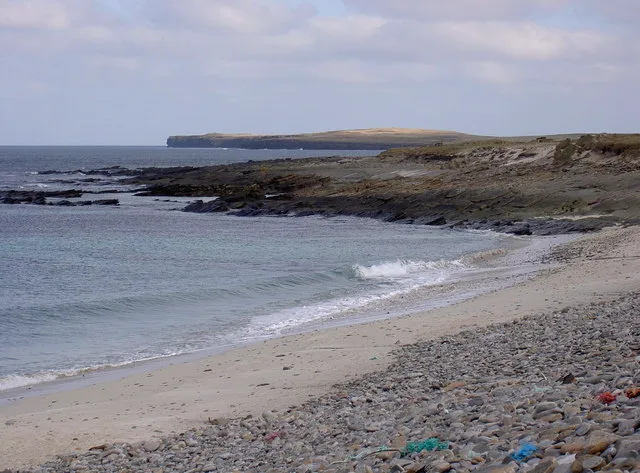 The Bay of Grobust on the north coast of Westray, Orkney — white sand backed by dunes, with cliffs beyond