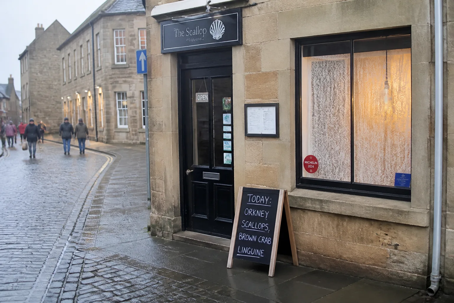 The exterior of a small independent seafood restaurant in central Stromness, Orkney — a sandstone shopfront with a black-painted door and a chalkboard A-board on the pavement reading TODAY: ORKNEY SCALLOPS, BROWN CRAB LINGUINE, with a single warm light glowing through the lace-curtained front window on a wet cobblestone street