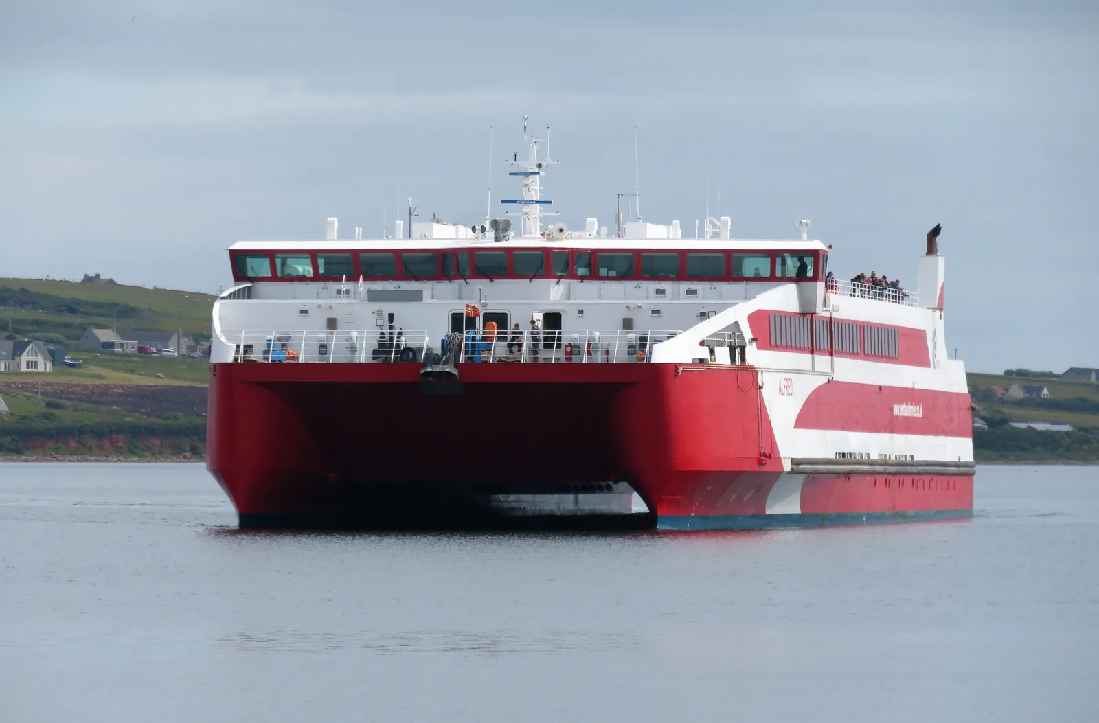 Pentland Ferries' red and white catamaran Alfred approaching St Margaret's Hope