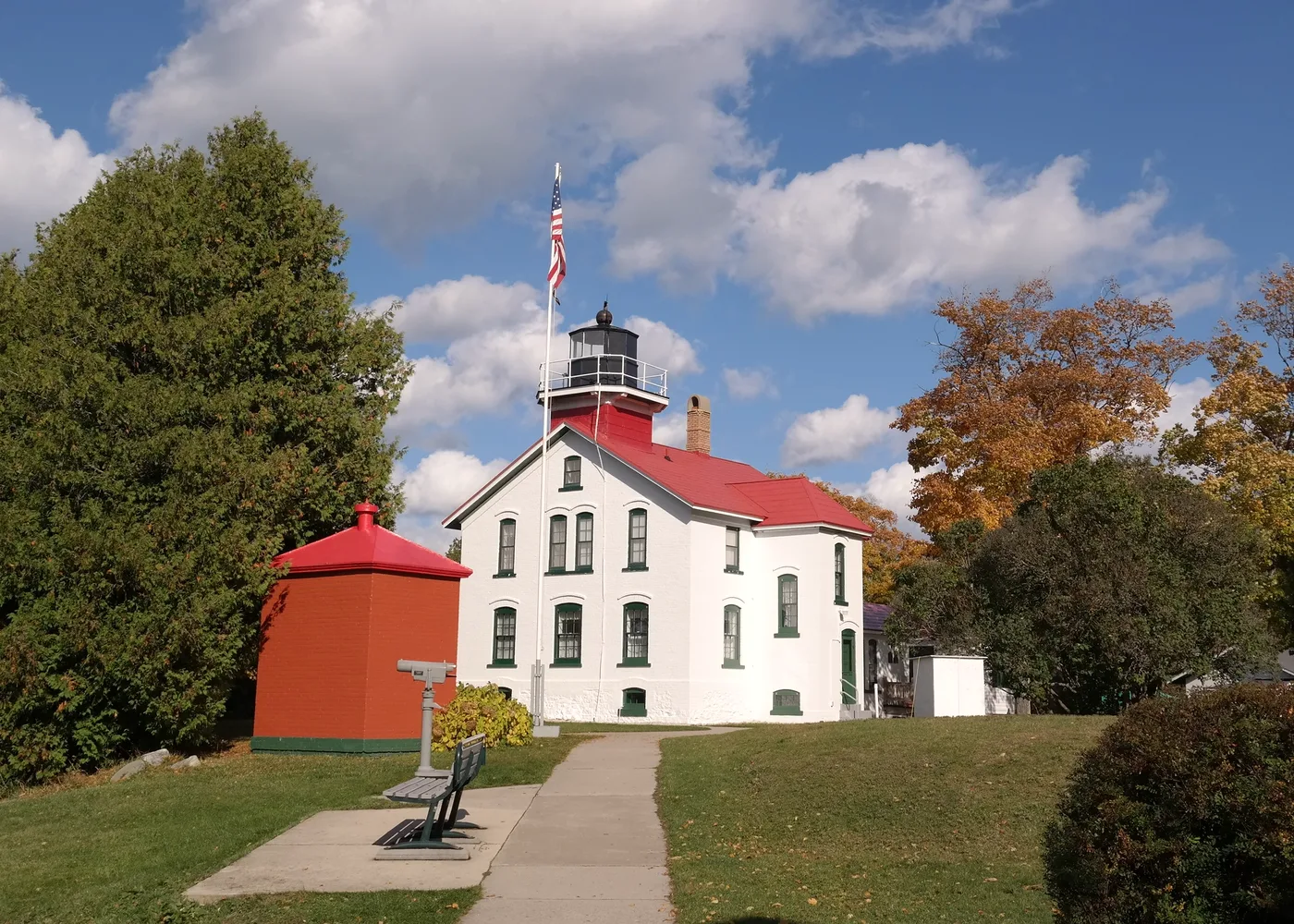 The red-and-white Grand Traverse Lighthouse standing at the tip of the Leelanau Peninsula in Leelanau State Park