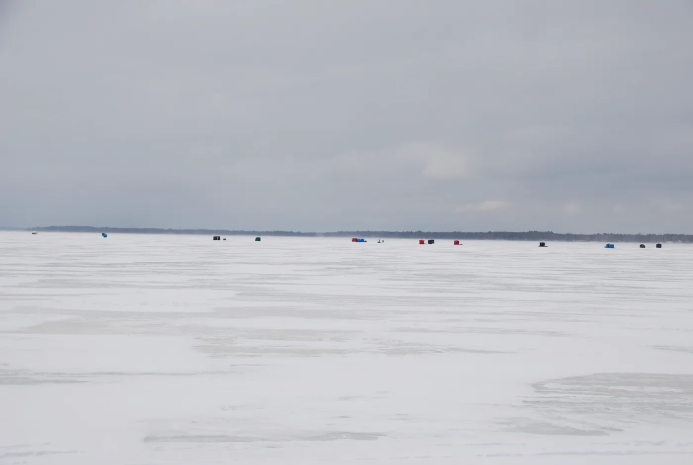 Colorful ice fishing shanties set up across the frozen surface of Houghton Lake during Tip-Up Town USA winter festival