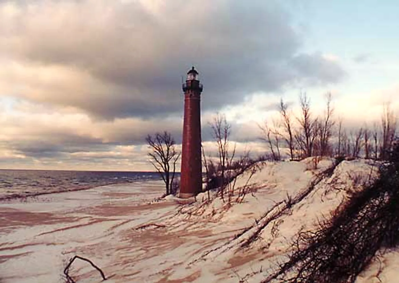 Little Sable Point Lighthouse tall red brick tower without a keeper's house rising above the Lake Michigan dune shoreline in Silver Lake State Park, Michigan