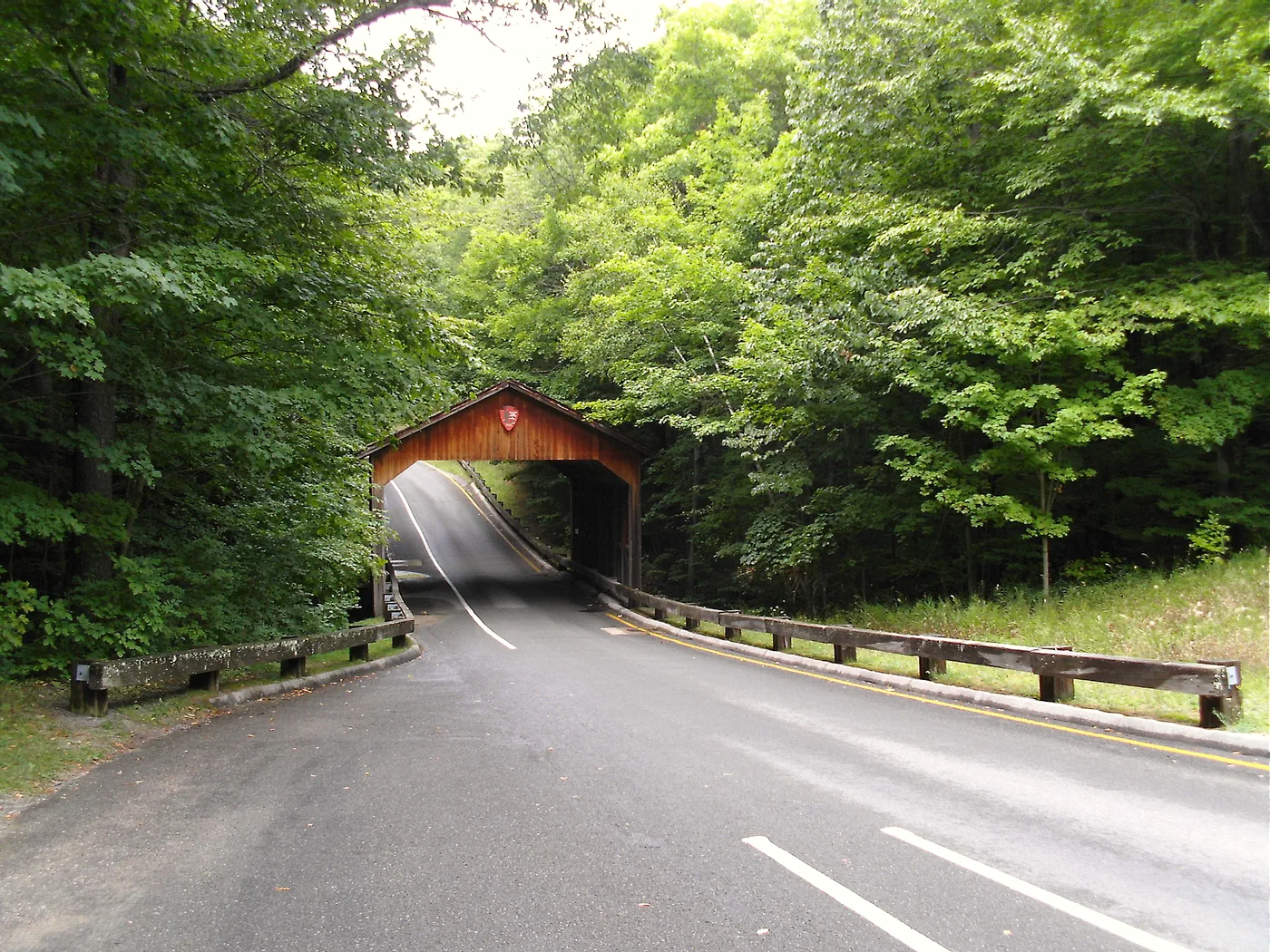 Wooden covered bridge carrying the one-way Pierce Stocking Scenic Drive through beech-maple forest in Sleeping Bear Dunes National Lakeshore