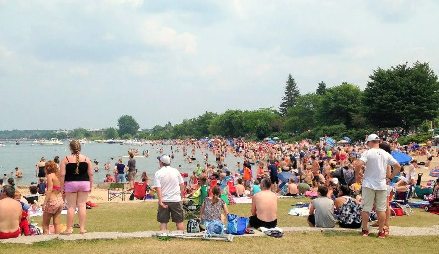 Clinch Park Beach on West Bay in downtown Traverse City, Michigan, with sandy shore and calm blue water