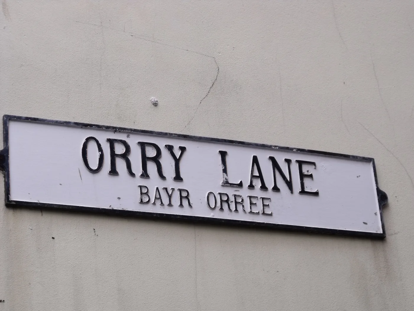 A white street sign in Peel reading Orry Lane in English with Bayr Orree in Manx beneath