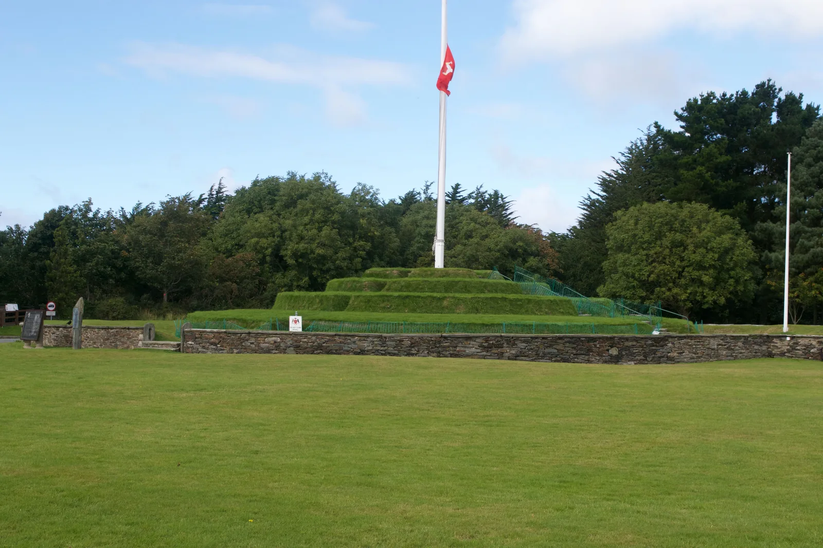 The four grassy tiers of Tynwald Hill at St John's, with the Manx flag flying from a pole at its centre