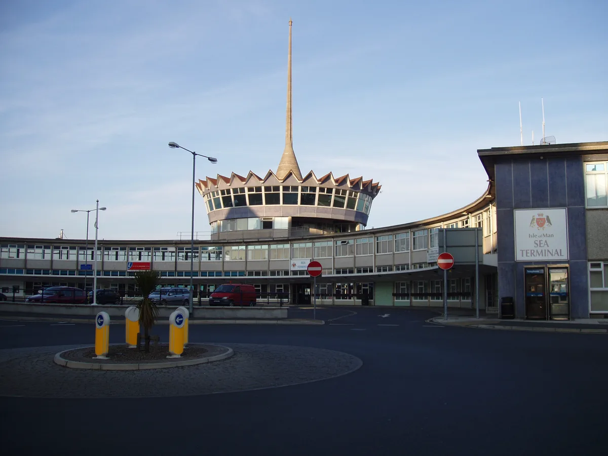 The Sea Terminal building in Douglas, with its distinctive spire, under a clear sky