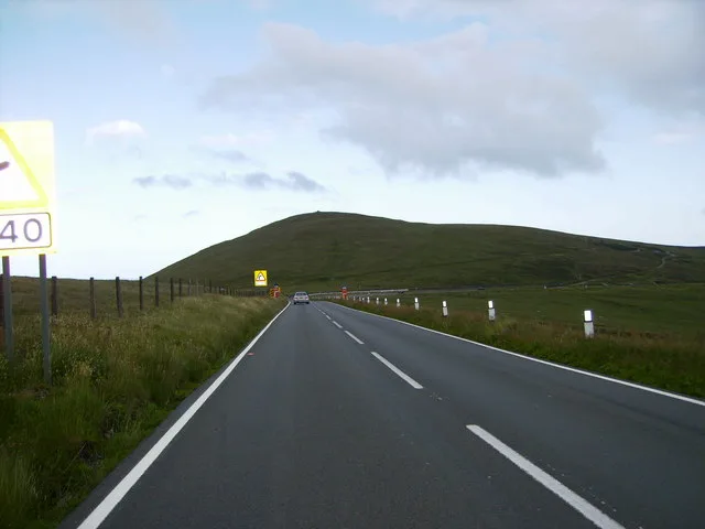 The open A18 Mountain Road climbing across bare moorland on the Isle of Man