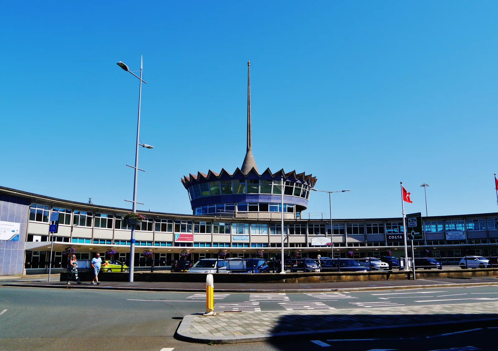 The Sea Terminal building in Douglas, with its crown-shaped rooftop and tall spire, under a clear blue sky