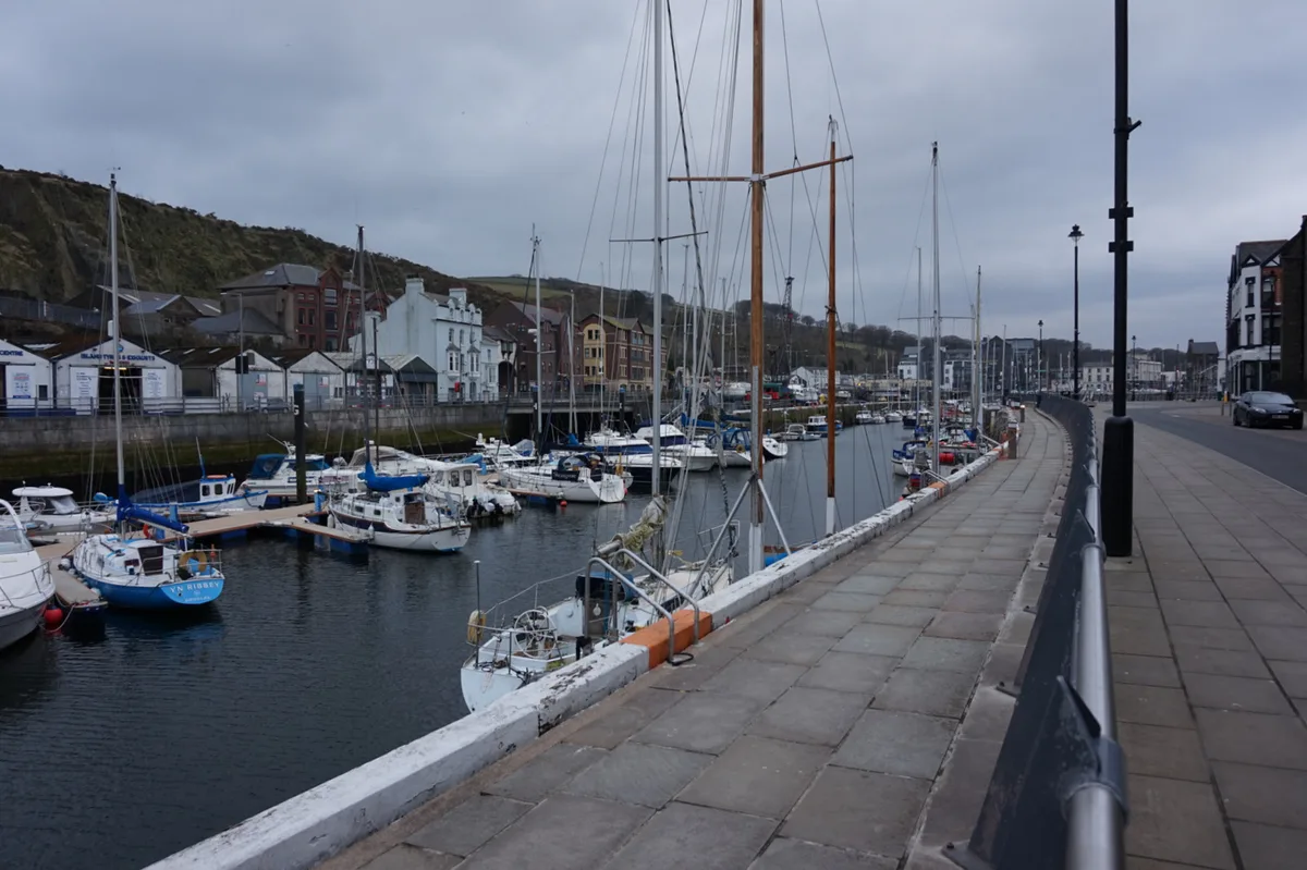 Boats moored in Douglas Marina with harbourside buildings behind
