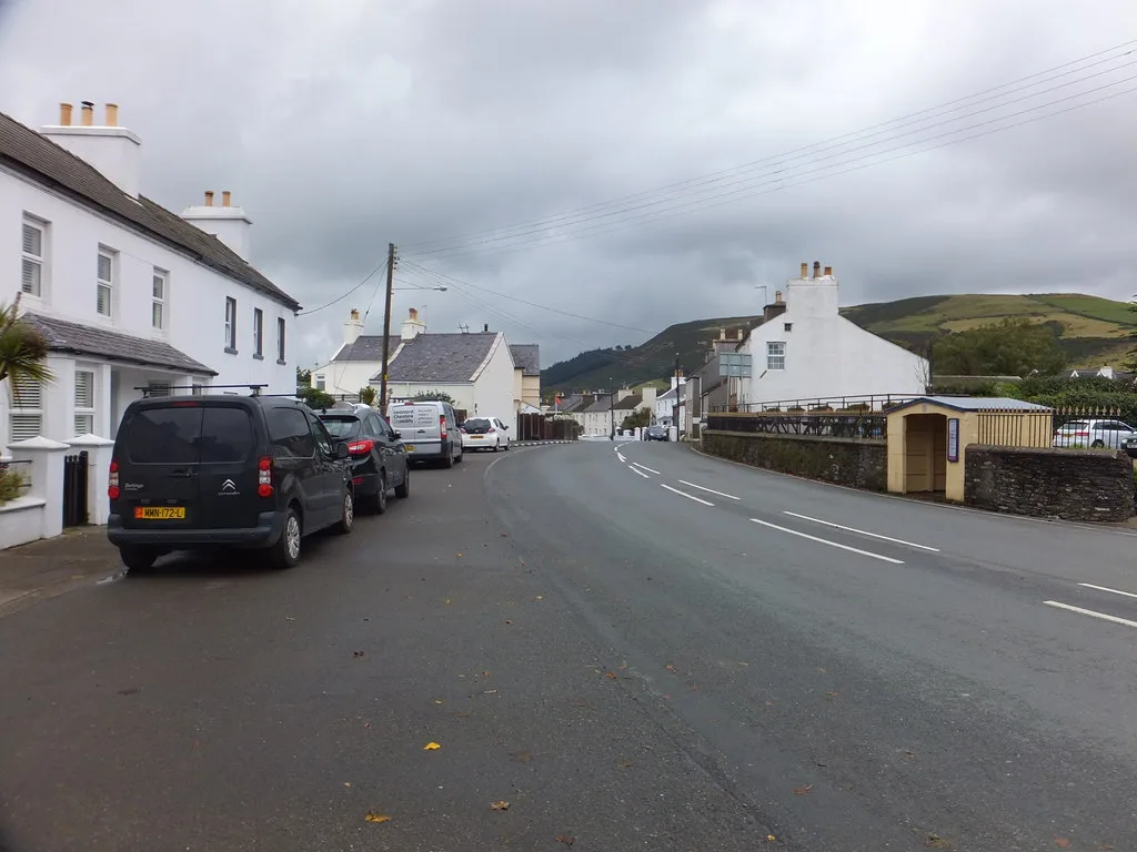 The A3 main road curving through Ballaugh village between whitewashed cottages