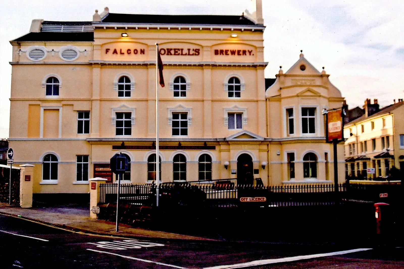 The cream-painted Falcon Brewery building on Falcon Street in Douglas with the name Okell's across its front
