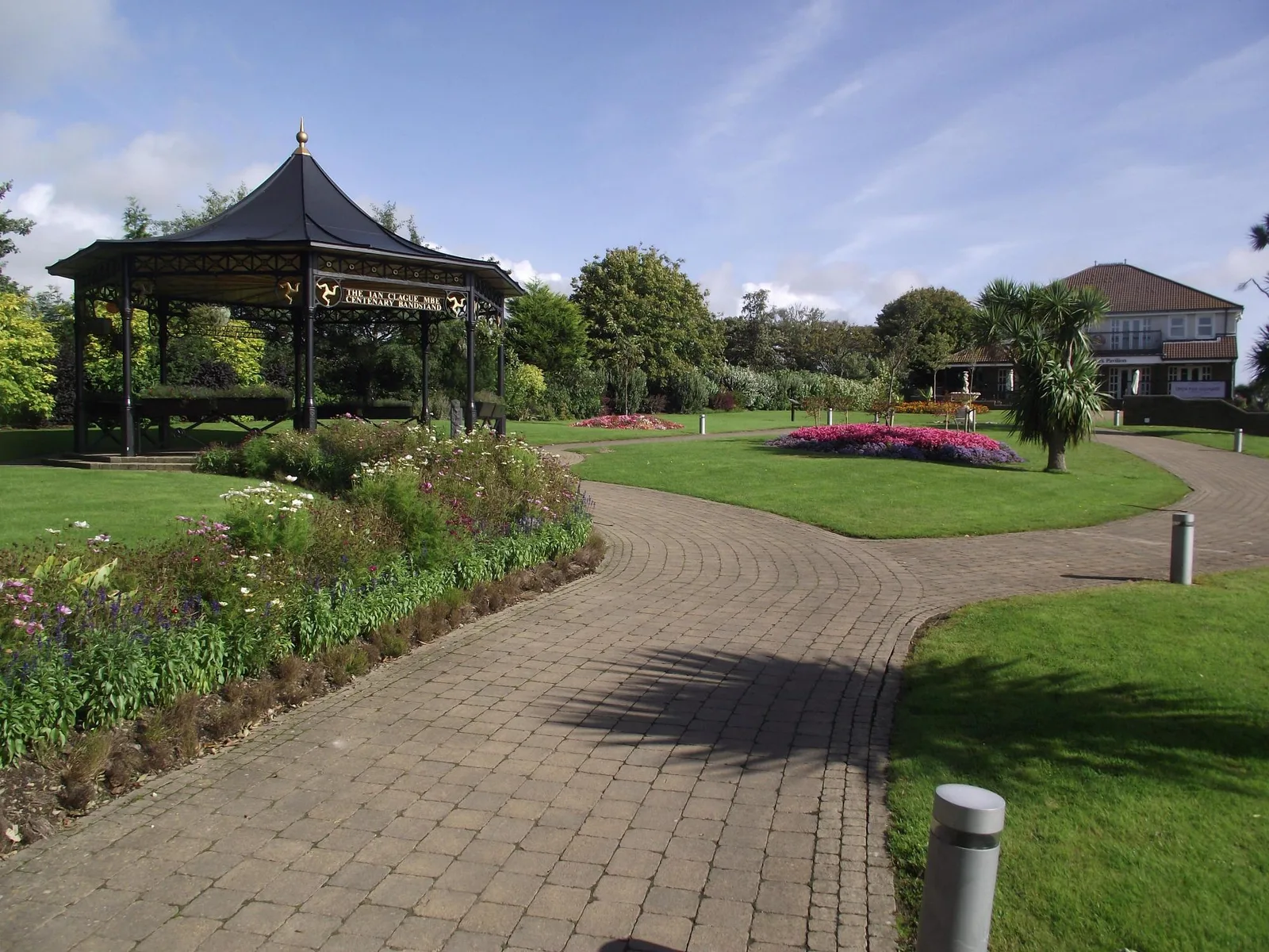 Brick paths, lawns, flower beds and a bandstand in Noble's Park, Douglas