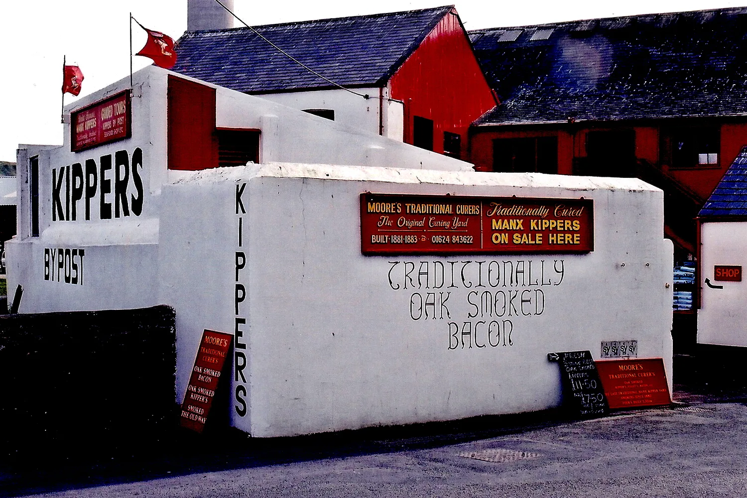 The whitewashed curing yard on Mill Road in Peel with the word KIPPERS painted across its wall