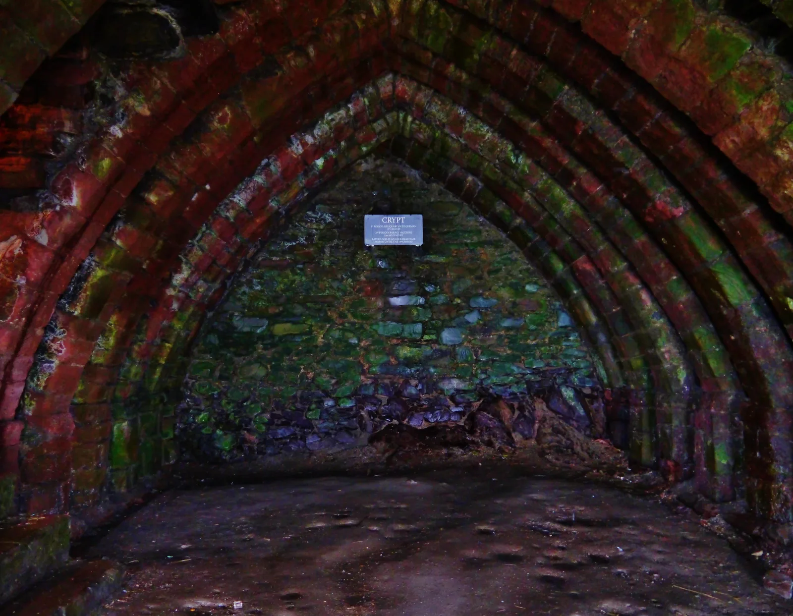 Stone steps leading down into the vaulted crypt beneath the ruined Cathedral of St German at Peel Castle