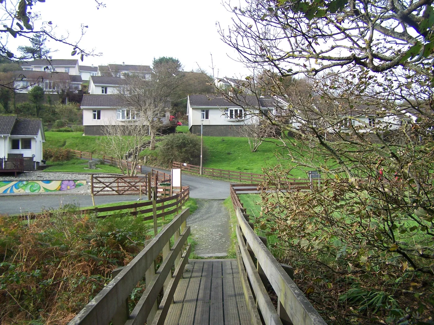 The Isle of Man coastal path running along a grassy cliff top above the sea at Groudle Glen