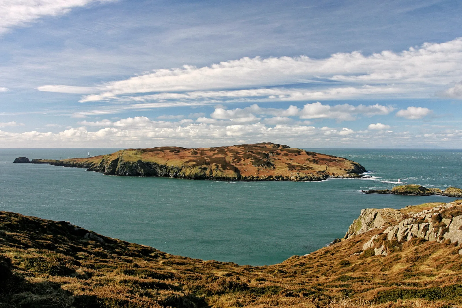 The Calf of Man seen across Calf Sound, with the islet of Kitterland and the Chicken Rock lighthouse visible in the distance