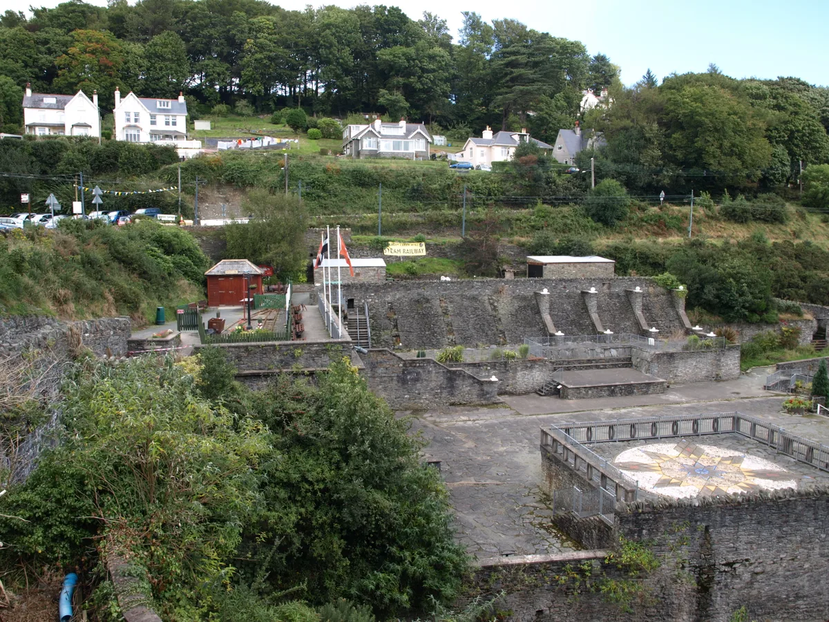 An elevated view over the old stone Washing Floors terminus of the Great Laxey Mines, arched walls set into the hillside above Laxey village