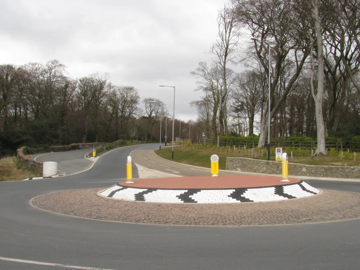 Governor's Bridge, a tight hairpin bend on the Snaefell Mountain Course lined by trees and stone walls