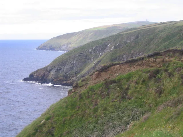 Green cliffs falling to the sea along the coast path north of Glen Maye, with headlands beyond