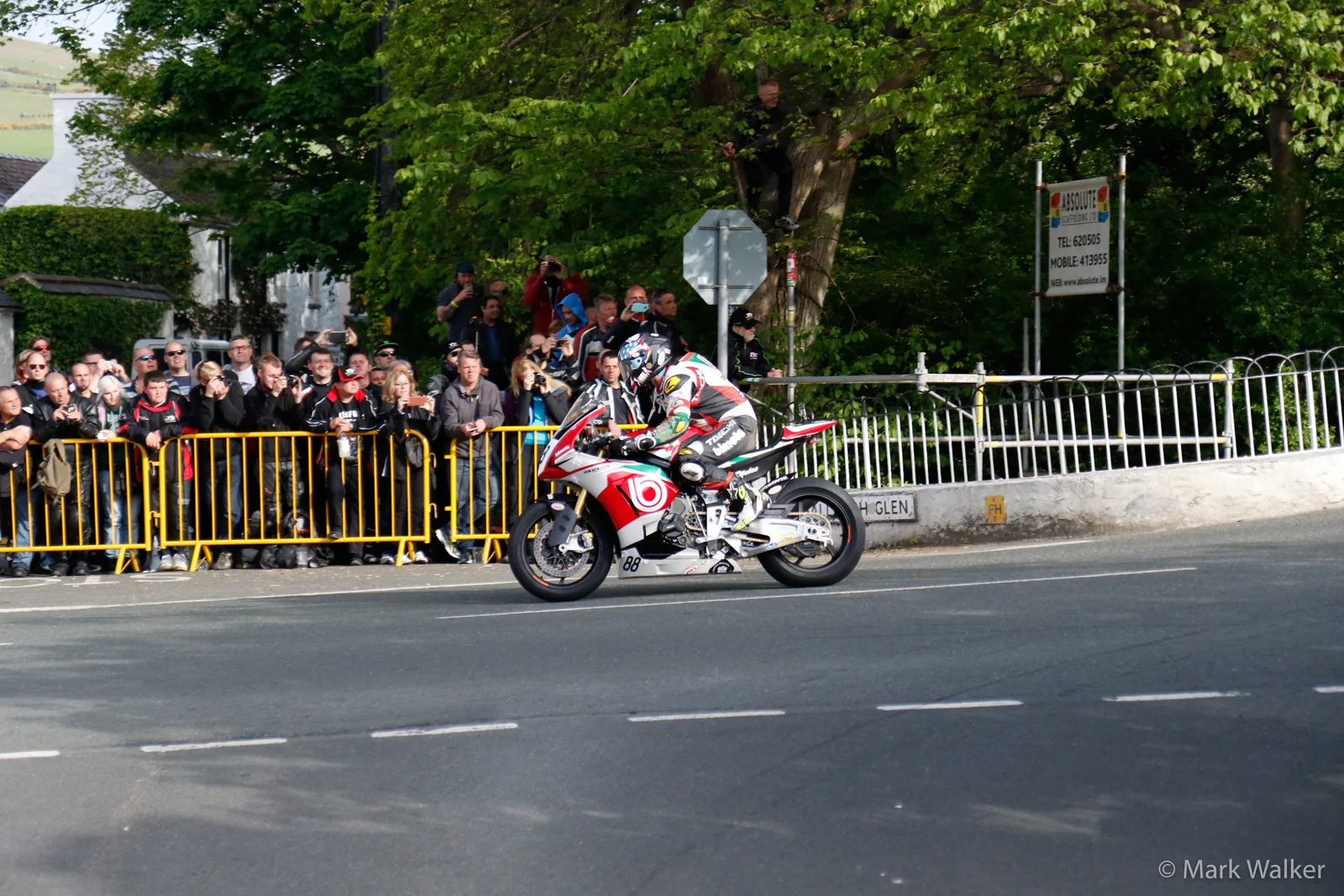 A racing motorcycle lifting its front wheel over the humpback at Ballaugh Bridge during the 2015 Isle of Man TT