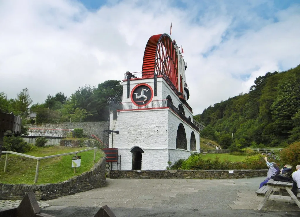The Great Laxey Wheel, a huge red water wheel on a white stone tower with arched openings