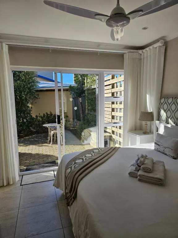 Bedroom with sliding doors opening onto a private paved courtyard