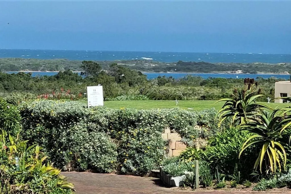 View from the garden over the 11th golf tee to the estuary mouth and open ocean beyond
