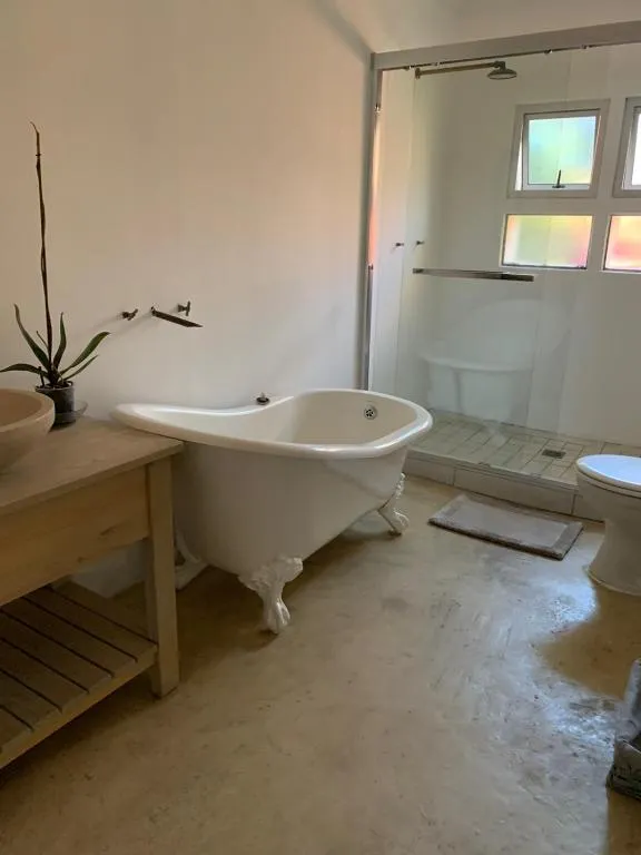 Bathroom with a freestanding clawfoot tub and separate glass shower