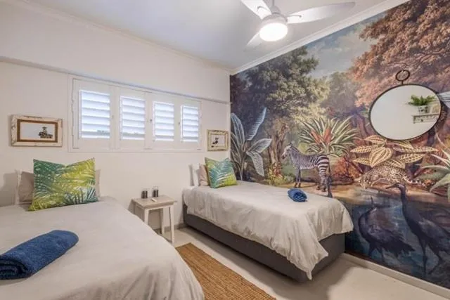 Living room with framed artwork, wall-mounted TV and striped curtains
