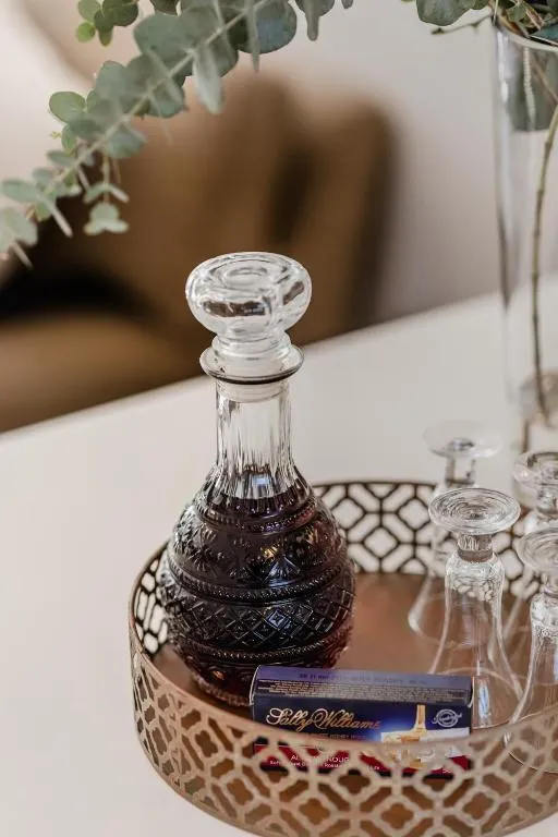 Welcome tray with a glass decanter, glasses and a chocolate liqueur box