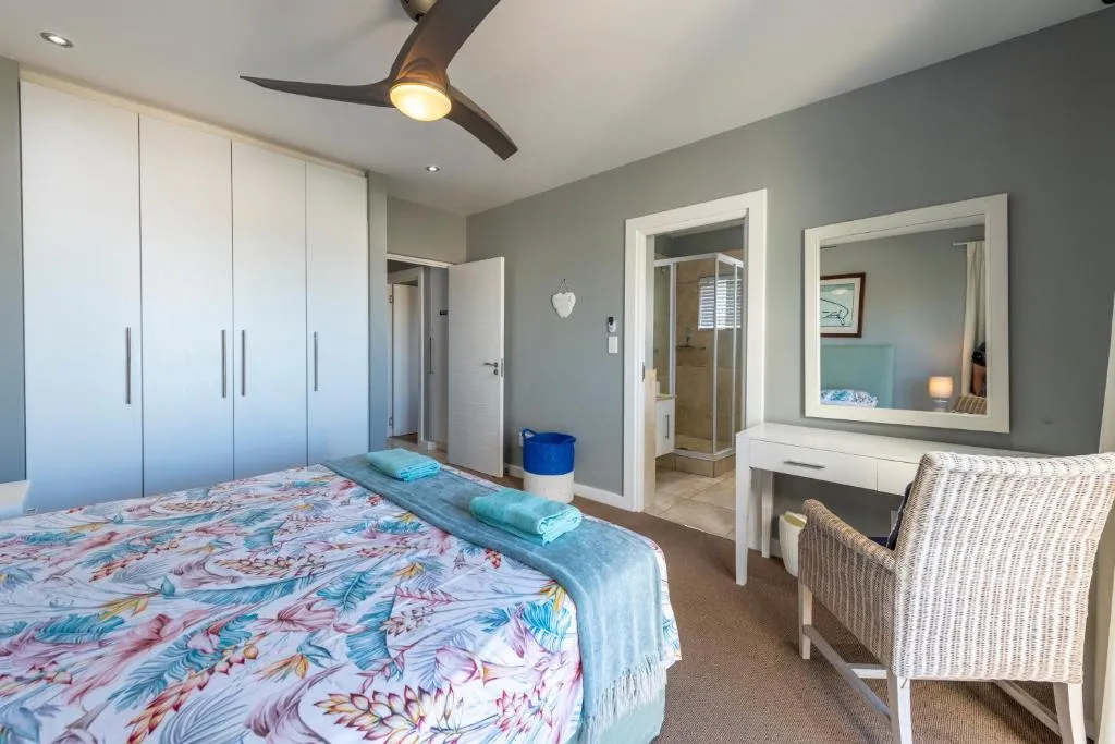 Bedroom with full-height fitted wardrobes and a door through to an en-suite shower room