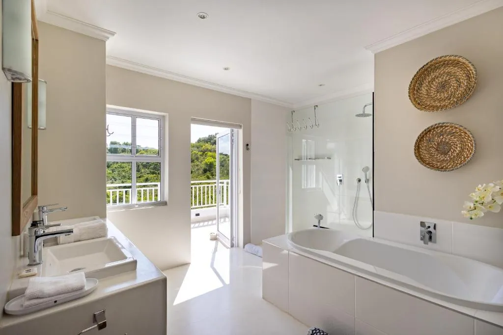 Bathroom with a freestanding tub, double vanity and a door onto the balcony