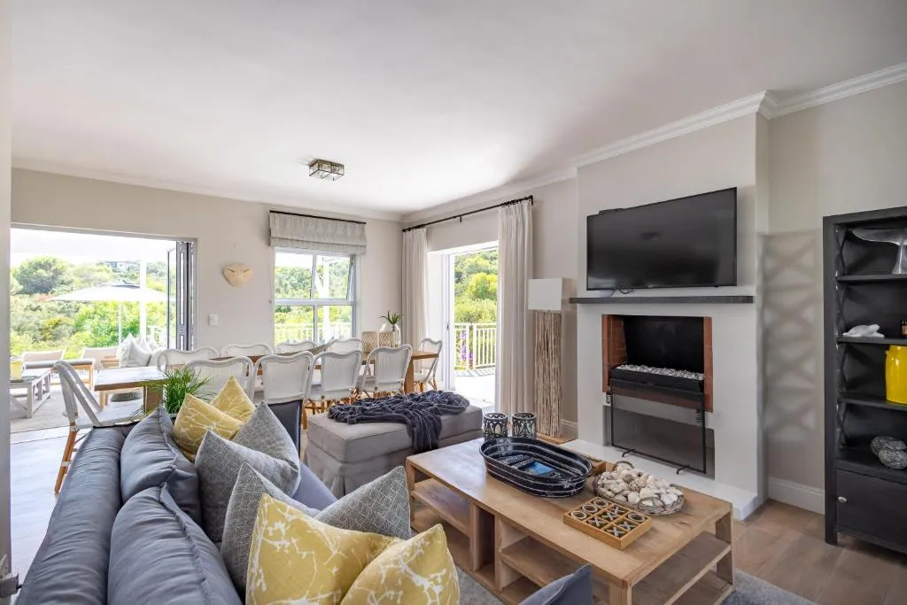 Living room with a grey sofa, built-in fireplace and wall-mounted television