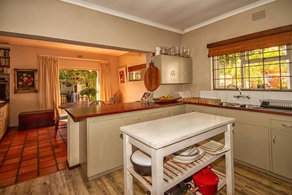 Kitchen with a central island, wooden cabinetry and a pass-through to the dining area