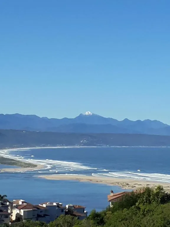 Elevated view over the Keurbooms lagoon, beach and mountains from the property's hillside setting