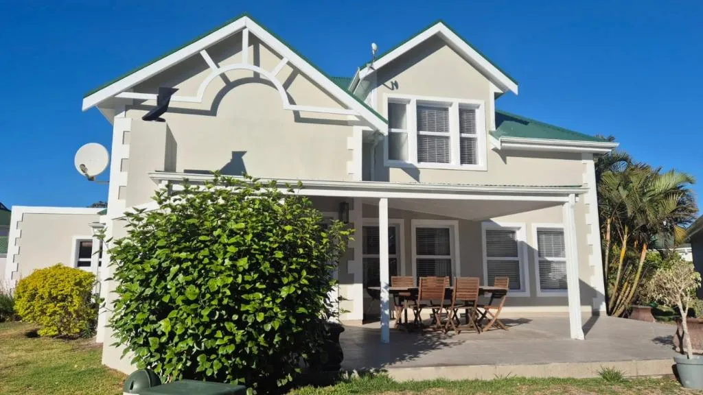 Double-storey home with a covered patio and outdoor dining table for six