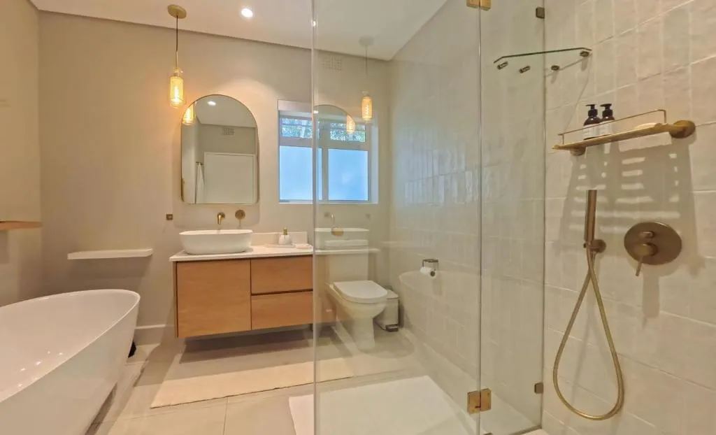 Bathroom with a freestanding tub, double vanity and a glass-enclosed walk-in shower