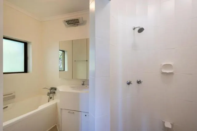 Bathroom with a tiled shower, freestanding tub and vanity with mirrored cabinet