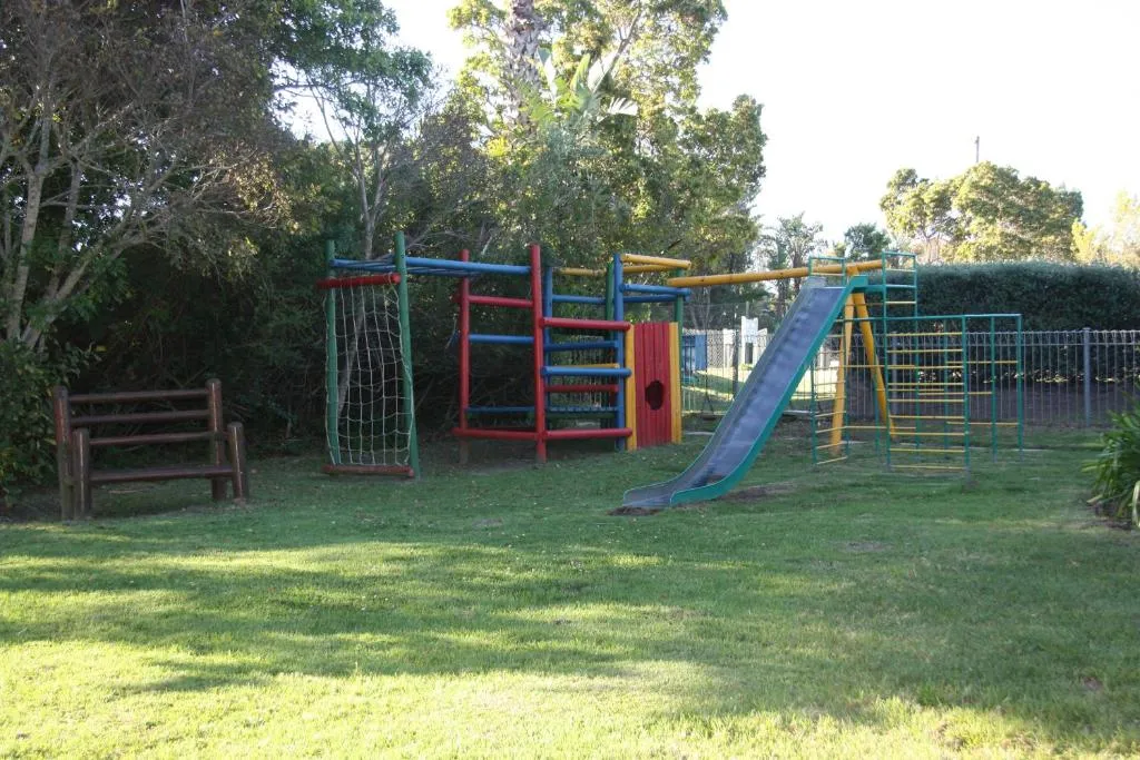 Children's jungle gym and slide on the complex's shared lawn