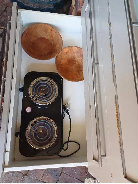 Two-plate electric hotplate stored in an in-room cabinet drawer for self-catering