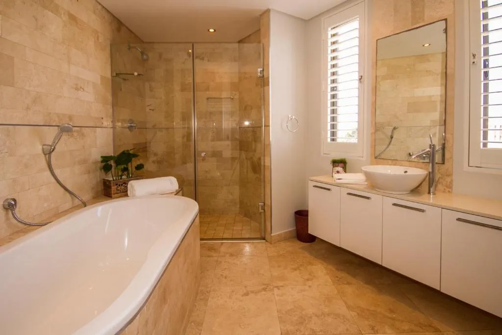 Bathroom with a freestanding tub, walk-in glass shower, and vessel basin