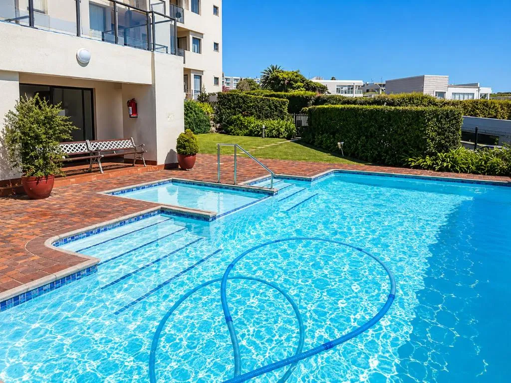 Close view of the complex's shared pool with steps and a built-in spa