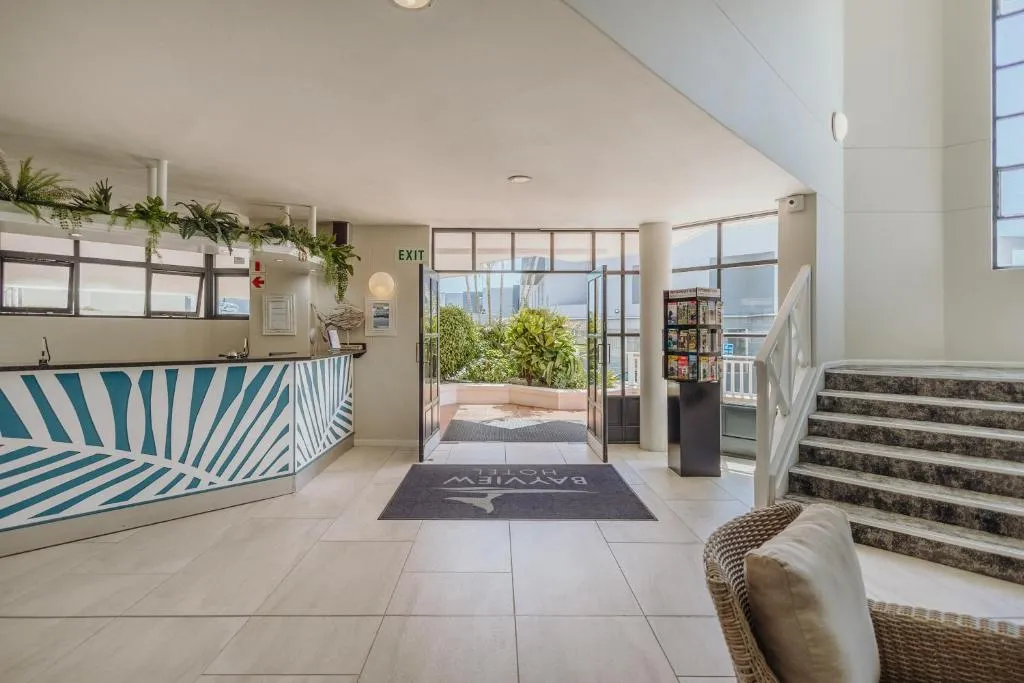 Reception desk with a patterned tile counter and staircase in the entrance lobby