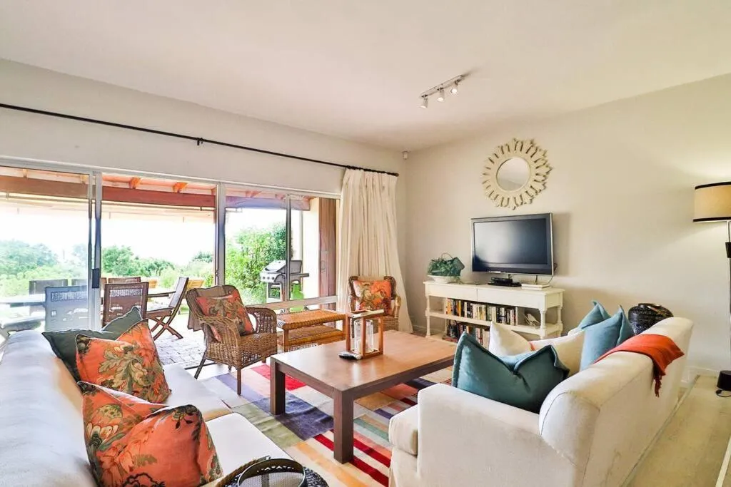 Living room with sliding doors opening onto the patio and garden