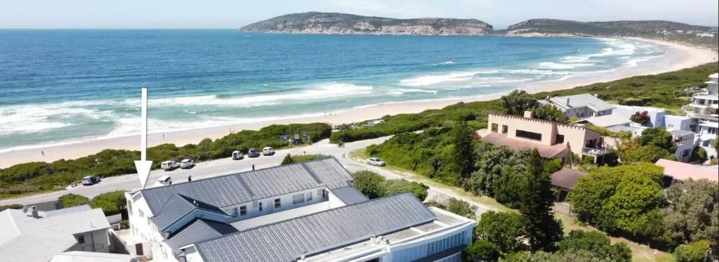 Aerial view of Robberg Beach with an arrow marking the building's position roadside