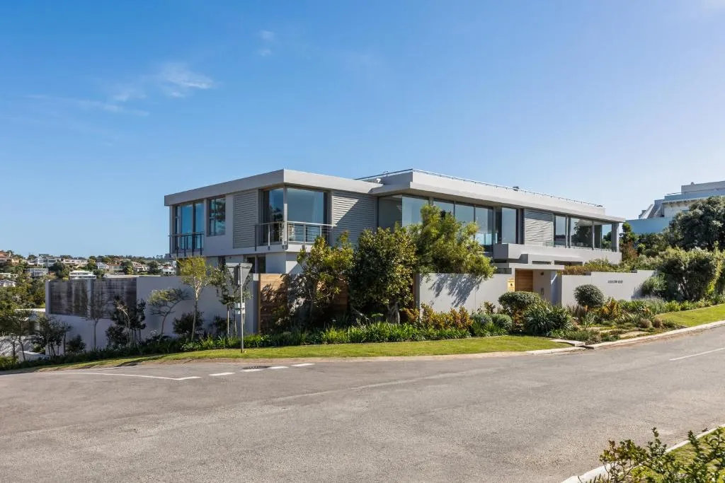 Modern double-storey villa with floor-to-ceiling glass, a landscaped garden and street frontage