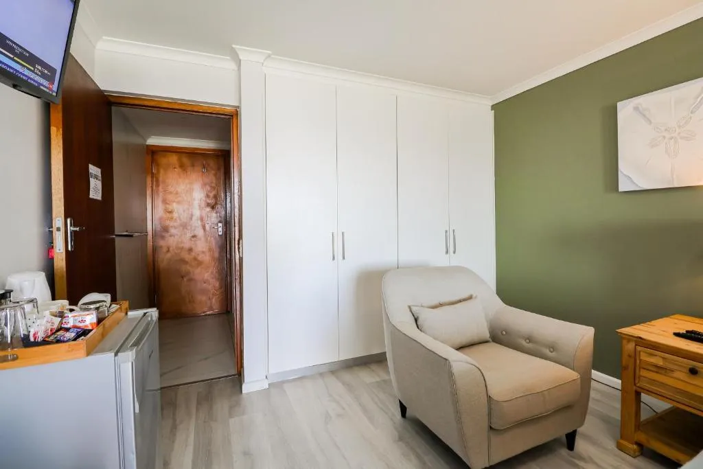 Bedroom with built-in white wardrobes and a green accent wall