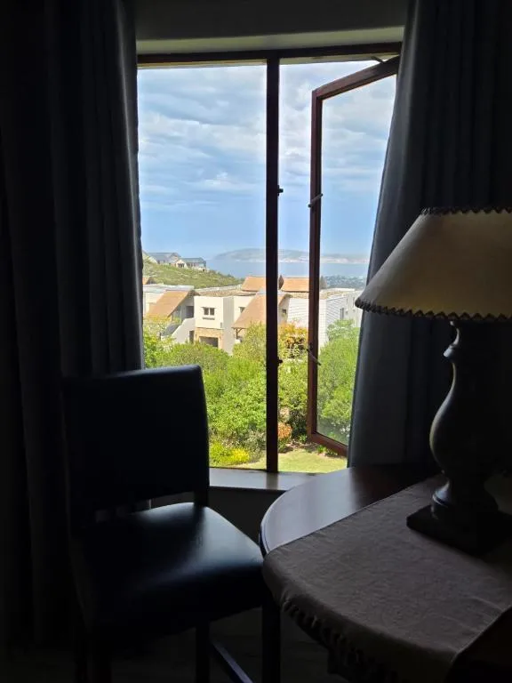 Reading nook overlooking gardens and rooftops toward the sea and headland