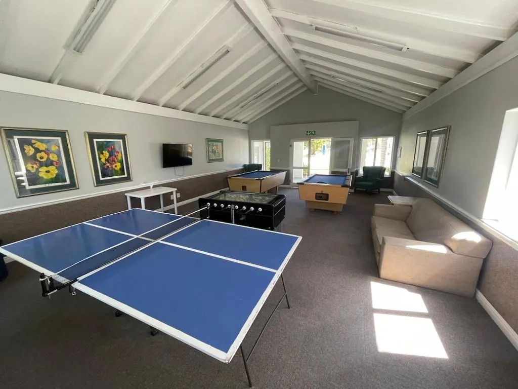 Estate games room with a table-tennis table, two pool tables and a table-football set